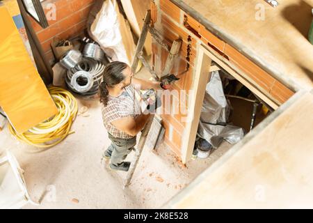 Strong man using stairs repairing a house Stock Photo