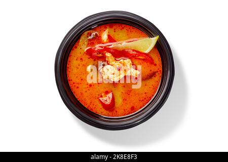 Bowl of Thai soup tom yam with chicken, red chili pepper and lemon Stock Photo