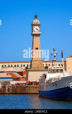 Stone tower with clock (Torre del Rellotge) one of the city most iconic buildings - built in 1772 in Port Vell, Barcelona Spain Stock Photo