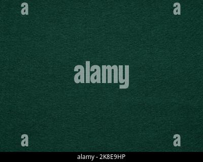 Dark green poker table felt soft rough textile material background texture close up with shade vignette. Soft pattern for text, lettering, patchworkor Stock Photo