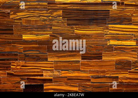 Tiger Eye Golden. Semiprecious texture as background. Mineral quartz beautiful golden-brown color with silky sheen. Material texture for unique Stock Photo