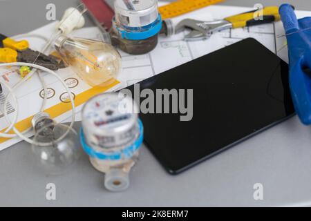 Architect working on blueprint. Architects workplace - architectural project, plan, drawing, sketch, ruler, blank tablet pc or smartphone, divider Stock Photo