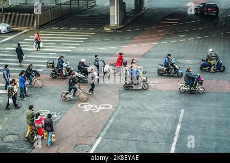 BEIJING China 23.02.2019 Pedestrians scooter and cyclists crossing the Bejing Street intersection. Stock Photo