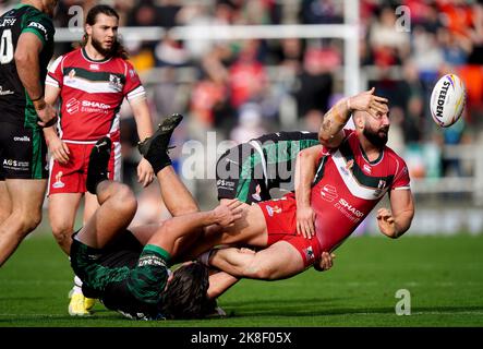 Lebanon's Kayne Kalache (right) is tackled by Ireland's Liam Byrne (left) during the Rugby League World Cup group A match at the Leigh Sports Village, Leigh. Picture date: Sunday October 23, 2022. Stock Photo