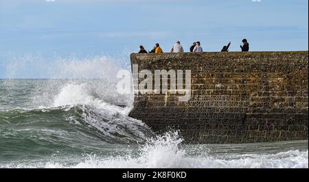 Brighton UK 23rd October 2022 - Visitors enjoy an unusually warm day for the time of year on Brighton seafront  today as temperatures are expected to reach 20 degrees in some parts of the South East  . : Credit Simon Dack / Alamy Live News Stock Photo