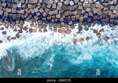 Aerial Drone View of a Concrete Breakwater. Breakwater in the Sea. Blue Atlantic Ocean Waters from Above. Stock Photo
