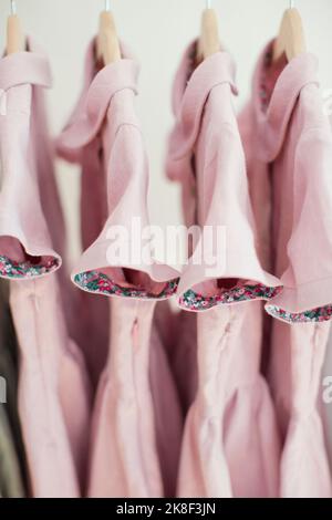 Pink dresses hanging on coathanger Stock Photo