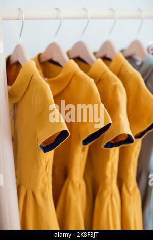 Yellow dresses hanging on coathanger Stock Photo