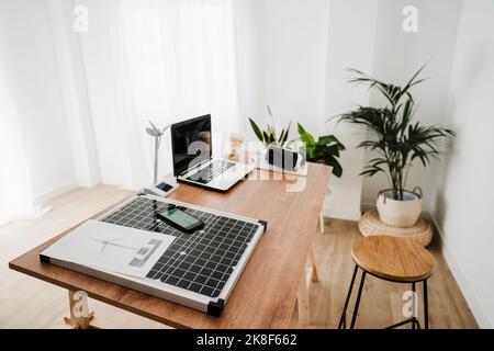 Portable solar panel and windturbine model on engineer's desk Stock Photo