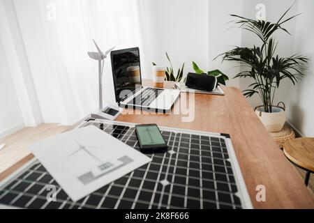 Portable solar panel and windturbine model on engineer's desk Stock Photo