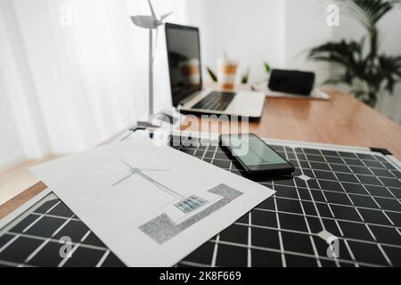 Portable solar panel and windturbine model on engineer's desk Stock Photo