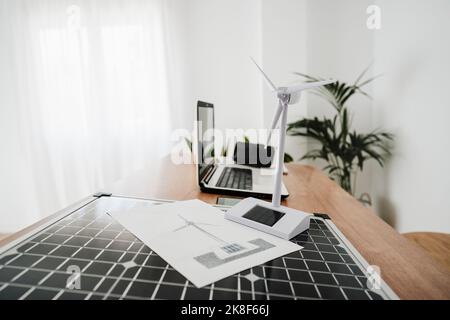 Portable solar panel and windturbine model on engineer's desk Stock Photo