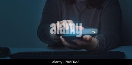 Woman using smartphone with VR search bar. SEO. Browser technology. Concept of searching on internet with copy space. Stock Photo