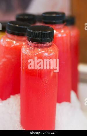 plastic bottles of red color soft drink in ice  Stock Photo