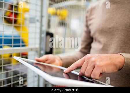 Hand of engineer using tablet PC at factory Stock Photo