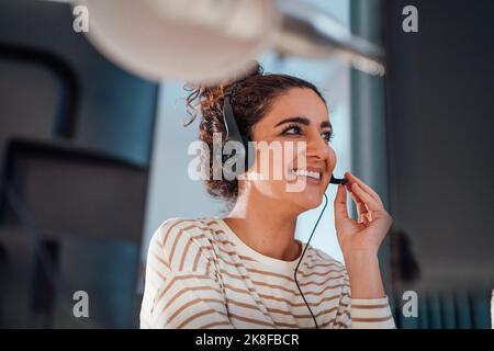 Customer service representative talking on headset in office Stock Photo