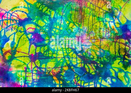 Organic texture made with colored liquid watercolor on white paper with drops going in all directions Stock Photo