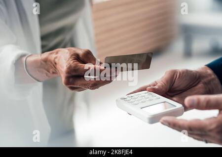 Hand of woman paying via credit card Stock Photo