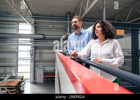 Mature businesswoman and businessman in industry Stock Photo
