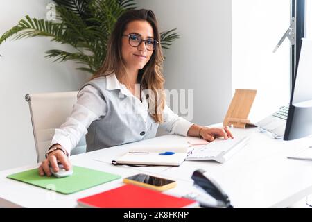 Smiling lawyer using desktop PC at office Stock Photo