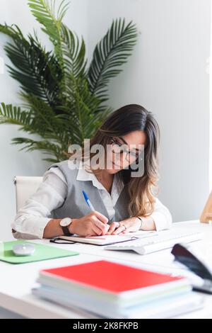 Young advocate making notes in office Stock Photo
