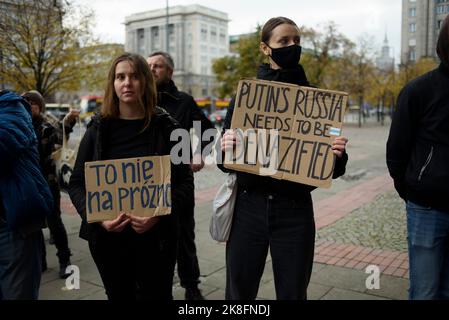 Warsaw, Warsaw, Poland. 23rd Oct, 2022. Protesters hold signs as they rally against war in Ukraine on October 23, 2022 in Warsaw, Poland. A few dozen of Russian citizens living in Poland rallied against the Russian attack on Ukraine and Vladimir Putin's regime under the slogan ''Solidarity against war''. Their supporters from Ukraine, Belarus and Poland also took part in the rally. (Credit Image: © Aleksander Kalka/ZUMA Press Wire) Credit: ZUMA Press, Inc./Alamy Live News Stock Photo