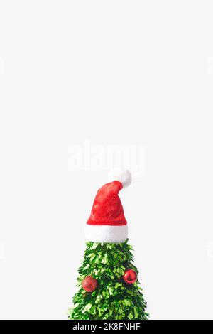 Christmas tree made of green confetti with santa hat on top against white background Stock Photo