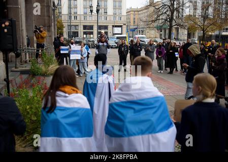 Warsaw, Warsaw, Poland. 23rd Oct, 2022. Protesters wrapped in white-blue-white flags symbolizing free Russia take part in a rally against war in Ukraine on October 23, 2022 in Warsaw, Poland. A few dozen of Russian citizens living in Poland rallied against the Russian attack on Ukraine and Vladimir Putin's regime under the slogan ''Solidarity against war''. Their supporters from Ukraine, Belarus and Poland also took part in the rally. (Credit Image: © Aleksander Kalka/ZUMA Press Wire) Credit: ZUMA Press, Inc./Alamy Live News Stock Photo