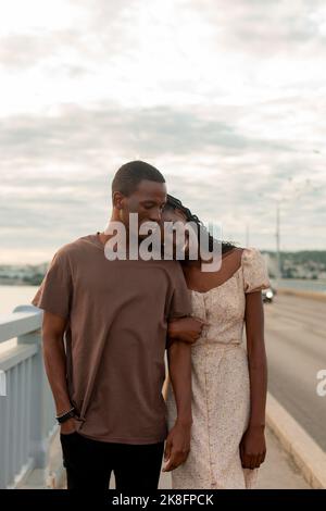 Young couple walking together on bridge Stock Photo