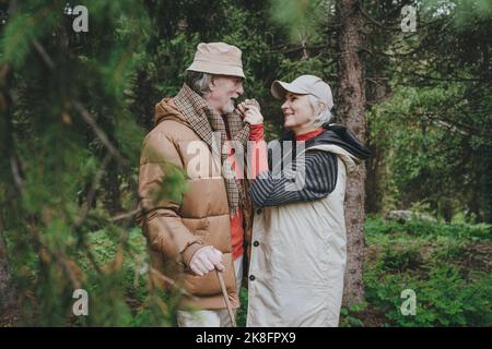 Happy couple standing together in forest Stock Photo