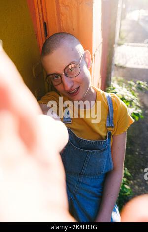 Non-binary person with eyeglasses taking selfie Stock Photo