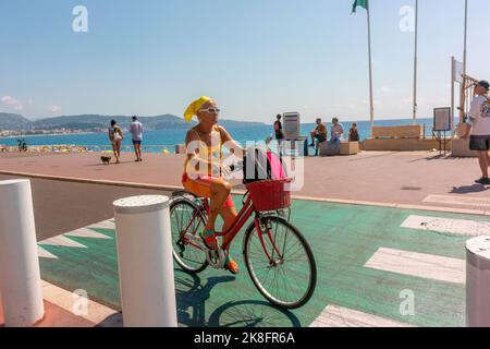 Nice, France, Senior french riviera woman Cycling on Street Scenes, Near Mediterranean Sea Beach Stock Photo