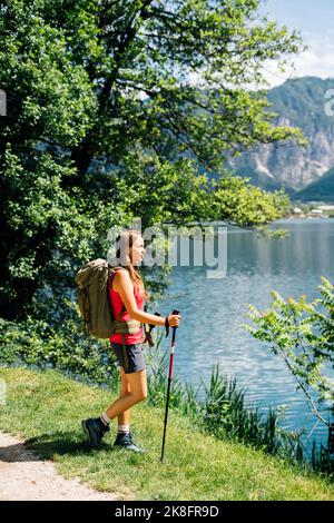 Young woman standing near Lake Levico on sunny day Stock Photo