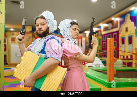 Man and woman like baby gangsters with guns Stock Photo