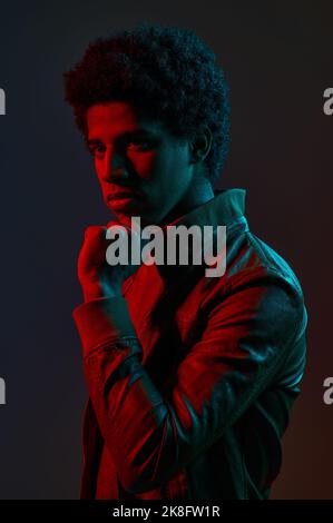Portrait of young stylish man in neon red Stock Photo