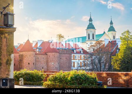 Warsaw Barbican and ancient church at sunset in autumn, Poland Stock Photo