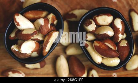 Macro. Large brazil nuts in a bowl. Peeled nuts. Stock Photo