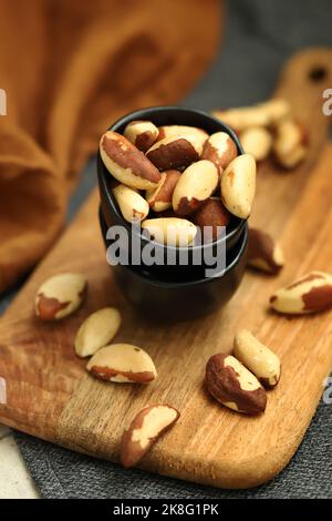 Macro. Large brazil nuts in a bowl. Peeled nuts. Stock Photo