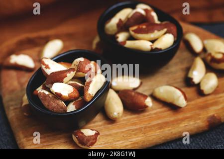 Macro. Large brazil nuts in a bowl. Peeled nuts. Stock Photo