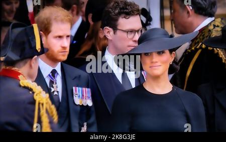 HARRY & MEGHAN The Duke and Duchess of Sussex at the funeral of Queen Elizabeth II departing St Georges Chapel Windsor Castle Berkshire UK A serious Prince Harry and a smiling Meghan Markle together on the steps of the Royal Chapel 19 Sep 2022 Stock Photo