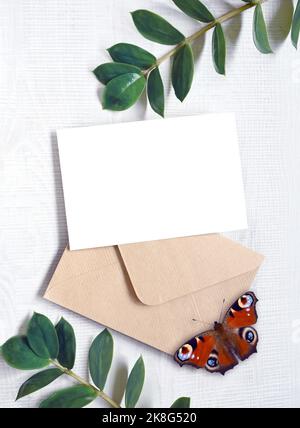 Mock up card with plants and butterfly. Invitation card with envelope on white background Stock Photo