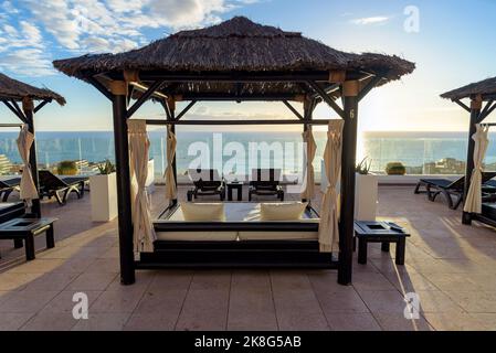 Balinese beds on the terrace overlooking the ocean as a vacation theme Stock Photo