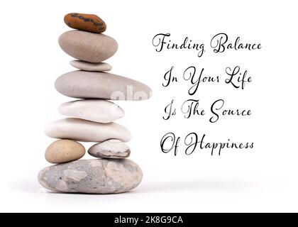 Zen balance in life slogan. Single stack of natural beech zen stones isolated on white background Stock Photo
