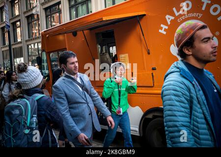 Ice cream lovers line up at the Halo Top “Pumpkin Responsibly” truck for samples of the brand’s Pumpkin Pie flavor ice cream and pumpkin pie flavored lattes (made with Halo Top) in the NoMad neighborhood of New York on Wednesday, October 19, 2022. Halo Top is owned by Wells Enterprises, also the maker of Blue Bunny ice cream. (© Richard B. Levine) Stock Photo