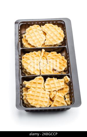 Broken  round waffle in plastic pack isolated Stock Photo