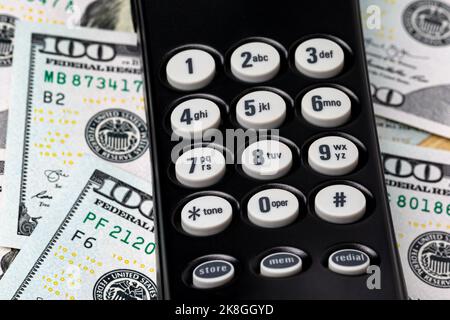 Telephone keypad and cash money. Telemarketing, robocall and phone scams concept Stock Photo