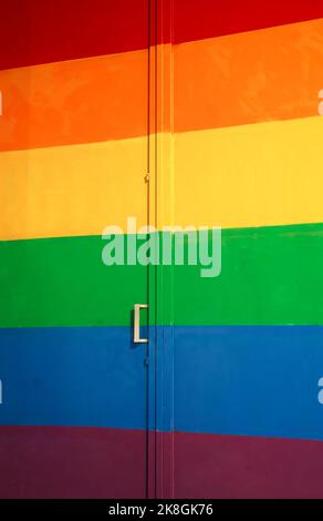 Full frame wall with door colored in bright colors of rainbow spectrum for pride concept Stock Photo
