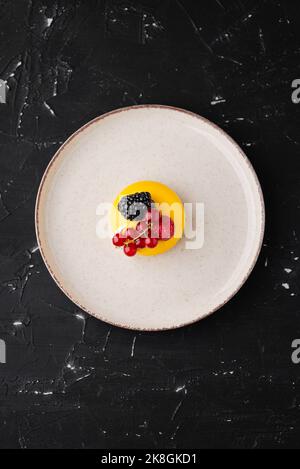 Top view yummy small cake with various natural berries served on plate on black table Stock Photo