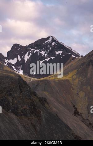 Picturesque view of Vestrahorn mountain range with snowy peaks under cloudy sky in winter Stock Photo