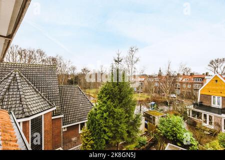 Views of multiple houses from the window under cloudy blue sky Stock Photo